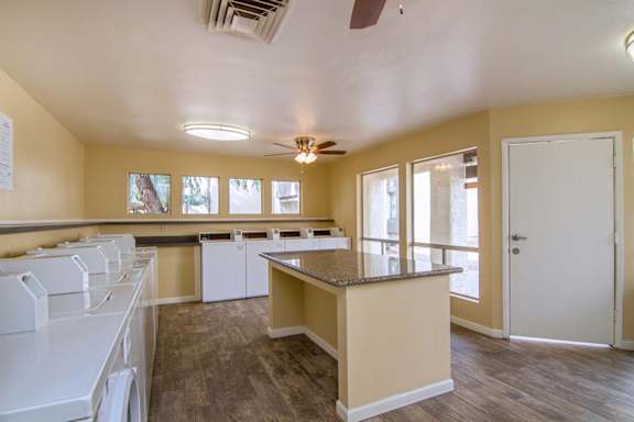 A kitchen with white appliances and a counter top.