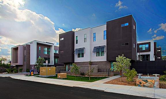 A modern building with a mix of brown and white exterior.