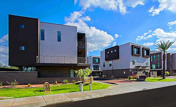 A modern building with a flat roof and large windows.