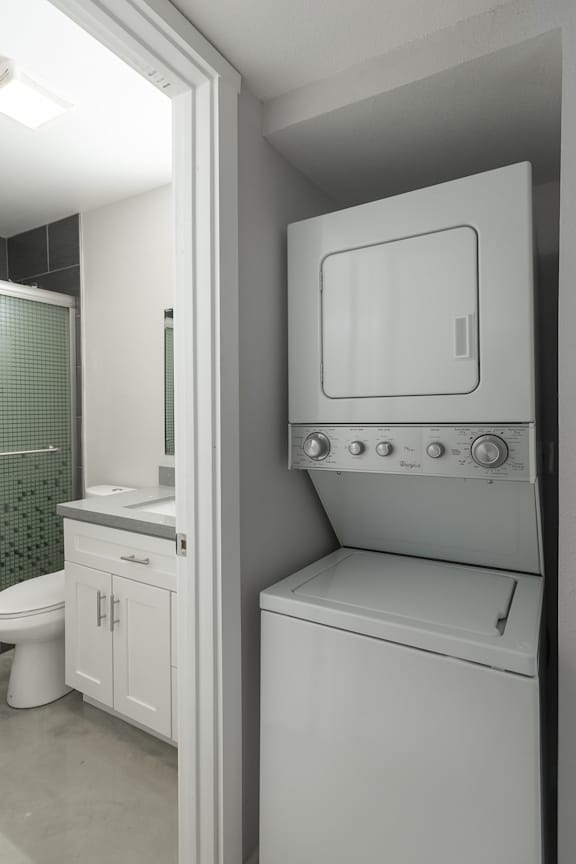 A white washing machine in a laundry room.