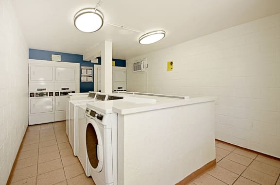 a kitchen with a washer and dryer and a counter with a washing machine