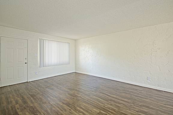 A room with a wooden floor and a white door.