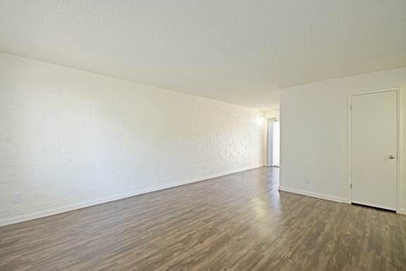 A room with a wooden floor and white walls.