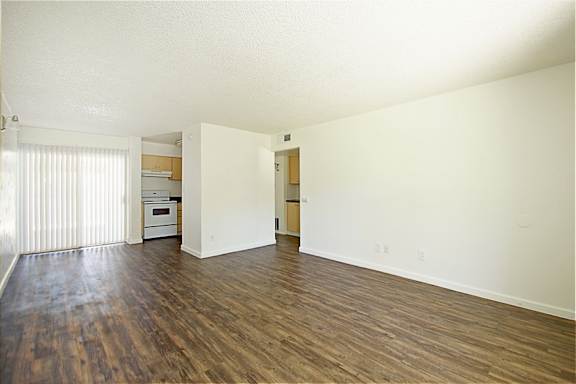 A room with wooden floors and white walls.