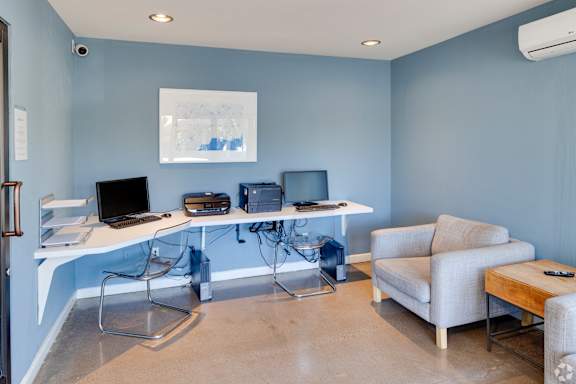 A room with a desk, chairs, and a couch. at The Viridian Apartments, Scottsdale, AZ, 85250