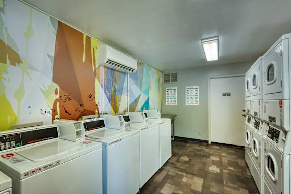 A row of washing machines in a laundromat.