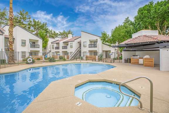 A swimming pool in front of apartment buildings.