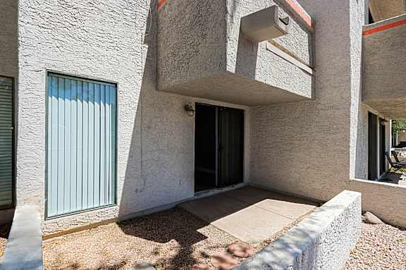 A modern house with a concrete exterior and a black door.