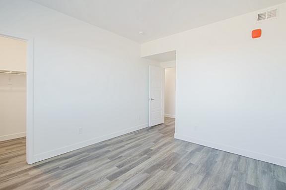 a room with white walls and wood flooring and a closet a room with white walls and wood flooring and a closet at 2051 Apartments, Prescott, Arizona