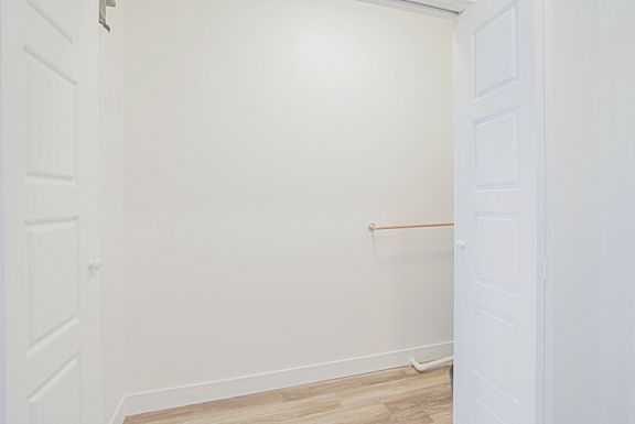 an empty room with a white wall and a closet an empty room with a white wall and a closet at 2051 Apartments, Prescott, Arizona