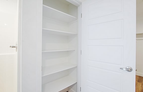a white closet with white shelves and a white door a white closet with white shelves and a white door at 2051 Apartments, Arizona, 86301
