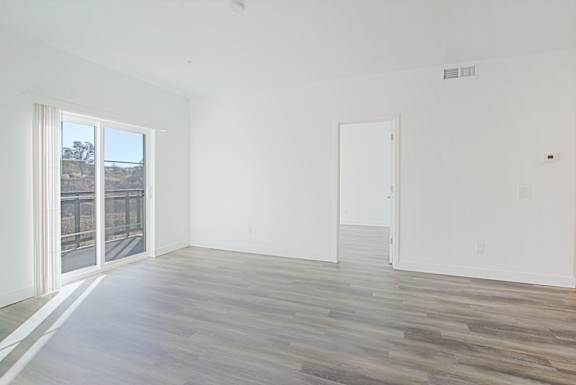 an empty room with white walls and a sliding glass door an empty room with white walls and a sliding glass door at 2051 Apartments, Arizona, 86301