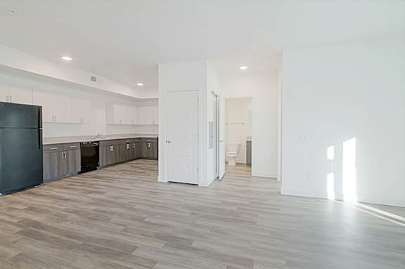 a room with white walls and doors and a wood floor at 2051 Apartments, Prescott, Arizona