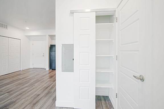 an empty living room with white walls and white closet doors at 2051 Apartments, Prescott, Arizona