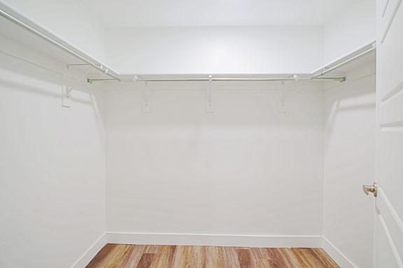 an empty room with white walls and a wood floor at 2051 Apartments, Prescott, Arizona