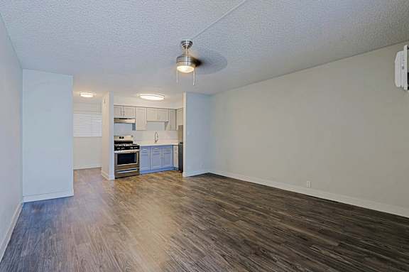 A kitchen with white cabinets and a stove top oven.