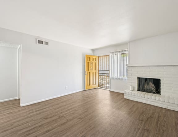 A room with a fireplace and a wooden door.