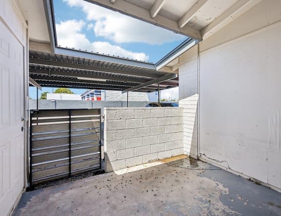 A white door is closed with a metal shutter on the side.