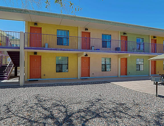 A building with yellow, orange, and green doors.