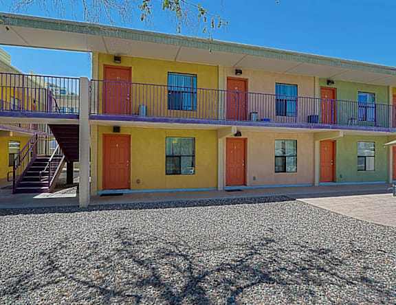 A building with yellow, orange, and green doors.