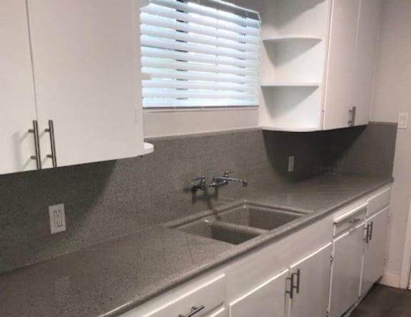 A kitchen with a sink and cabinets.