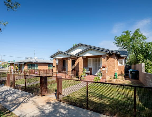 A house with a fence in front of it.