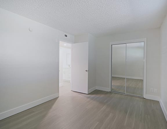 A room with a white door and a white wall.