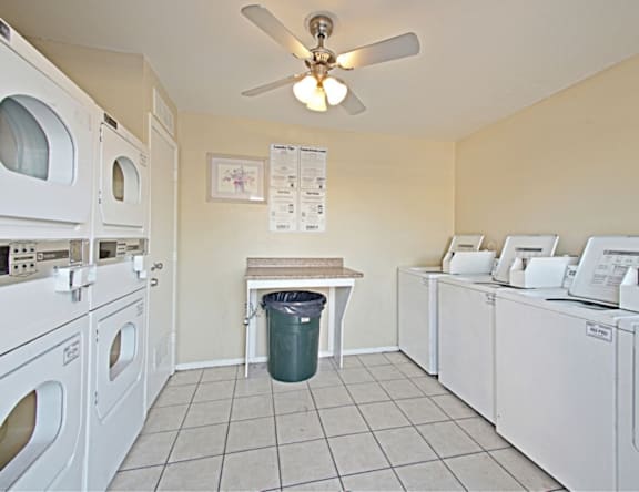 A laundry room with a washer and dryer on both sides of a table.