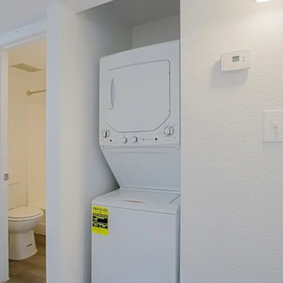 A white dishwasher with a sticker on it.