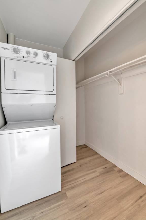 A white oven and dishwasher in a kitchen with wood flooring.
