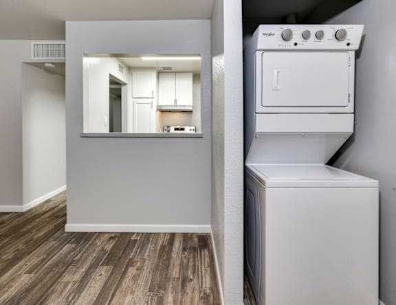 A white oven is in a room with wood flooring.