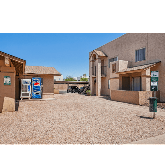 A Pepsi vending machine is located outside of a building.