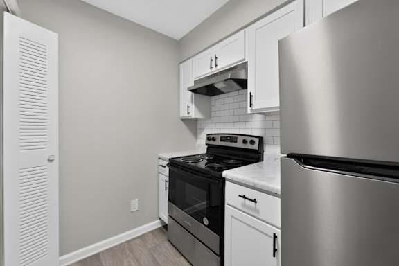 A kitchen with a stove, oven, and refrigerator.