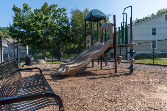 a playground with a slide at a park at Bradford Gwinnett Townhomes, Norcross