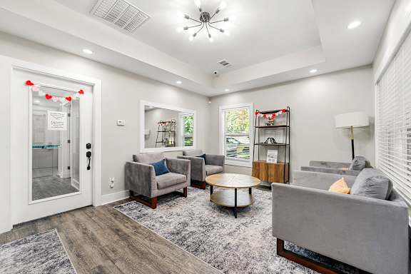 A living room with a grey couch and a coffee table.at Bradford Gwinnett Apartments and Townhomes, Norcross Georgia