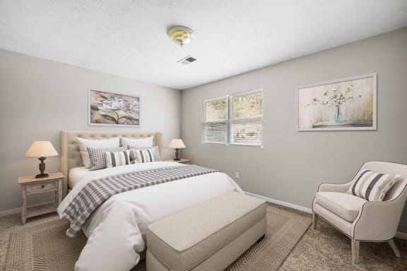 a bedroom with a bed and a chair at Bradford Gwinnett Townhomes, Georgia , 30071