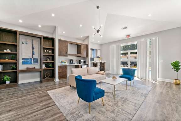 A modern living room with a blue chair and a white couch.