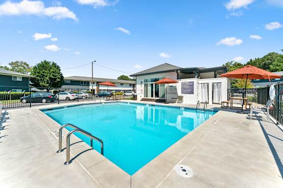 A large swimming pool with a metal ladder.