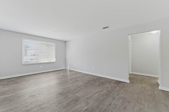 A room with a window and a door.