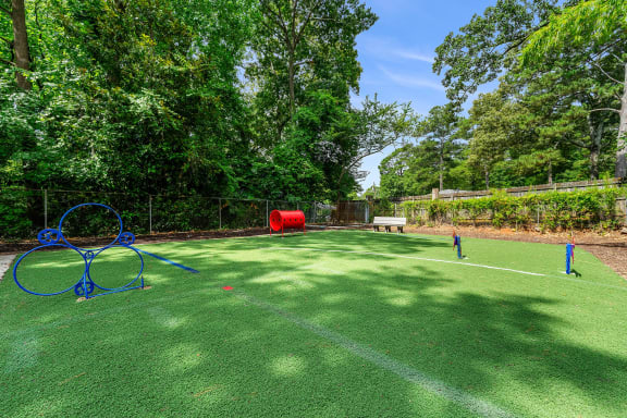 a tennis court with nets on it and trees at Georgian Oaks Apartments, Smyrna , 30080