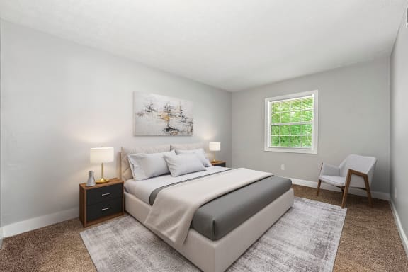 a bedroom with a bed and a chair and a window