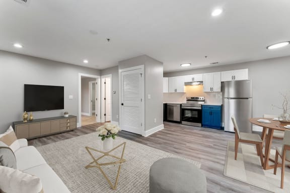 a living room and kitchen with a couch and a table at Woodbriar Management, LLC, Tucker, GA