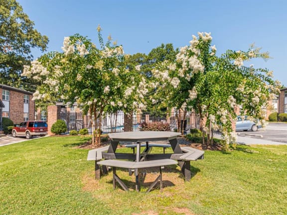 a picnic table in a park next to a parking lot at Georgian Oaks Apartments, Smyrna , Georgia