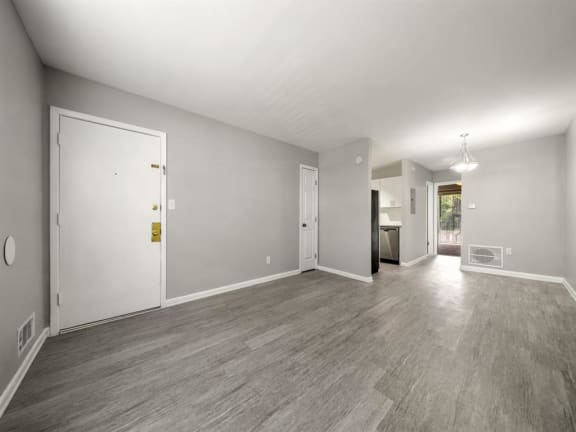 the living room and dining room of a house with a wood floor at Georgian Oaks Apartments l &amp; ll* Apartments, Smyrna , GA, 30080