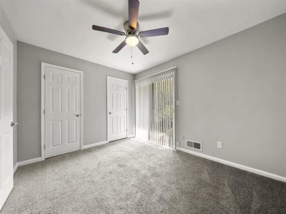 an empty living room with a ceiling fan and a window at Georgian Oaks Apartments l &amp; ll* Apartments, Smyrna