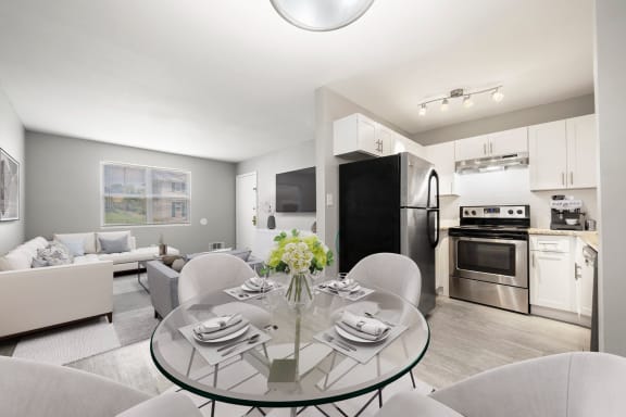 a living room with a glass table and a kitchen with stainless steel appliances at Georgian Oaks Apartments l &amp; ll* Apartments, Smyrna , 30080