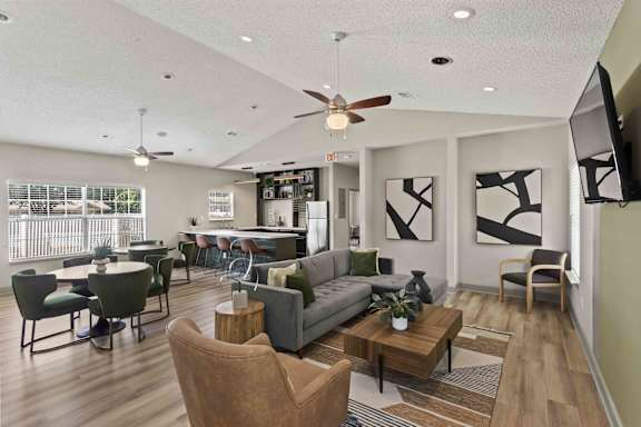 A living room with a couch, chairs, and a coffee table.