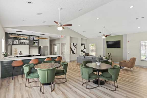 A modern dining room with a bar area and a television.