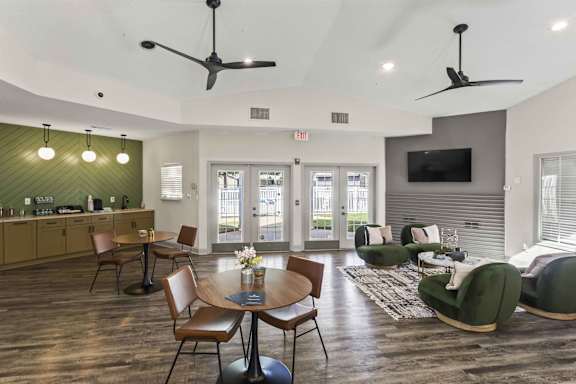 A modern living room with a wooden floor and a green sofa.