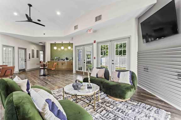A living room with a green couch and a coffee table.